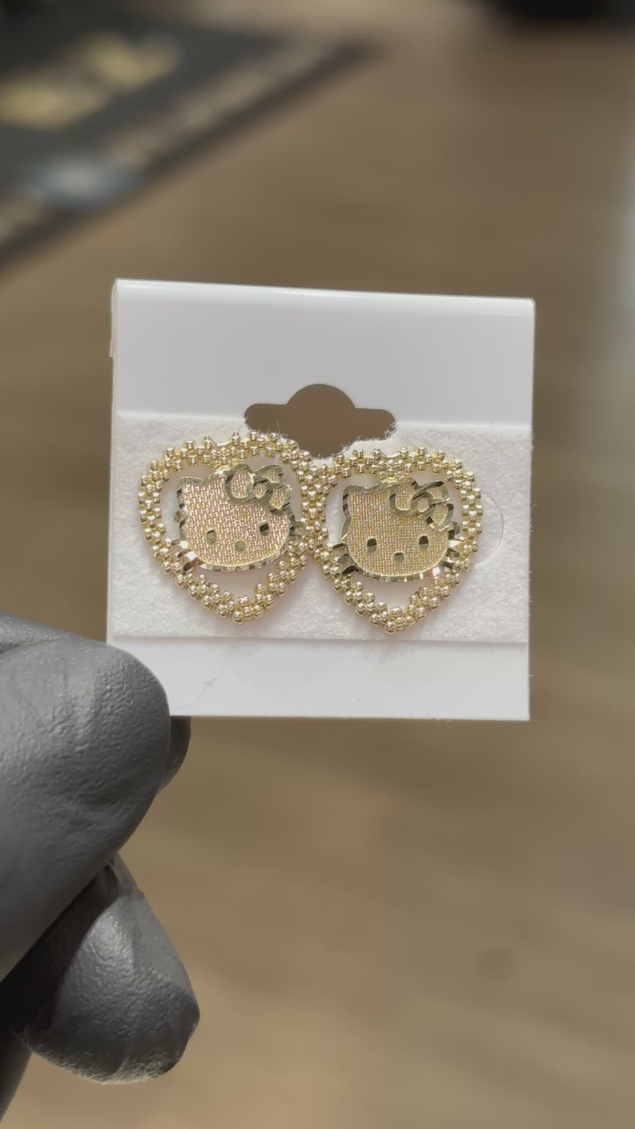 Load video: 10k Rolex Hello Kitty Head Earrings